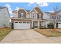Inviting two-story home boasts a stone facade, two-car garage, and well-manicured lawn at 2005 Ernesto Ln, Raleigh, NC 27603