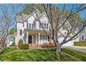 Well-maintained two-story home featuring a lush lawn and mature trees at 2812 Ashland Dr, Durham, NC 27705
