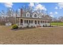 Charming two-story home with a welcoming front porch and traditional architectural details at 3068 Benson Rd, Angier, NC 27501