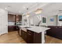 Well-equipped kitchen featuring stainless steel appliances, a center island, and a view of the living room at 3356 Longleaf Estates Dr, Raleigh, NC 27616
