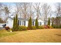 Well-maintained single-story home with lush greenery and a classic facade at 383 Hardy Rd, Wendell, NC 27591