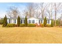 Inviting single-story home featuring a well-manicured lawn and traditional design elements at 383 Hardy Rd, Wendell, NC 27591