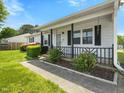 Inviting front porch with decorative railings and a well-maintained landscape at 4 Hannah Ct, Durham, NC 27713