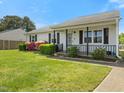 Quaint single-story home featuring a well-kept front lawn and inviting front porch at 4 Hannah Ct, Durham, NC 27713