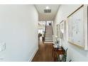 Inviting entryway with hardwood floors, staircase, and stylish decor setting a welcoming tone at 4007 Southpoint Landing Way, Durham, NC 27707