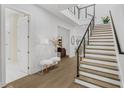 Elegant two-story foyer with hardwood floors and modern staircase showcasing the home's design at 4007 Southpoint Landing Way, Durham, NC 27707