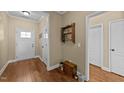 Inviting foyer features hardwood floors and a view of the front door and adjacent hallway with storage at 420 Carsons Creek Trl, Wendell, NC 27591
