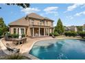 Spacious backyard with a large swimming pool and covered patio at 5026 Clyden Cv, Raleigh, NC 27612