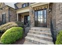 Inviting front entrance with stone steps and decorative door at 5026 Clyden Cv, Raleigh, NC 27612