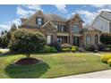 Charming brick home with lush green lawn and mature trees at 5026 Clyden Cv, Raleigh, NC 27612