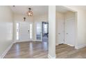 Bright foyer featuring wood-look flooring, a pendant light, and a glimpse into the living area at 60 Silent Brook Trl, Franklinton, NC 27525