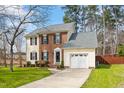 Inviting two-story home with a combination of brick and yellow siding, and an attached garage at 6524 Caverstone Dr, Durham, NC 27713
