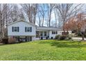 Inviting two-story home with a lush green lawn, showcasing its classic design and well-maintained landscaping at 6812 Valley Dr, Raleigh, NC 27612