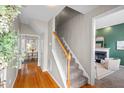 Inviting hallway with hardwood floors leading to a cozy living area and a bright dining space at 7 Dardanelle Ln, Durham, NC 27713