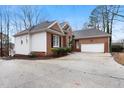 Lovely home with an attached garage and manicured shrubs surrounding a long, paved driveway at 715 Thompson Rd, Garner, NC 27529