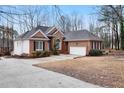 Beautiful home with brick and white siding, a two-car garage, and a well-maintained driveway at 715 Thompson Rd, Garner, NC 27529