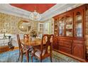 Charming dining room featuring wood table, chandelier, and a china cabinet with warm, inviting decor at 721 Thompson Rd, Garner, NC 27529