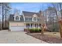 Traditional two-story home with attached garage, featuring manicured front yard and inviting entrance at 721 Thompson Rd, Garner, NC 27529