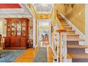 Bright foyer with hardwood floors and staircase, showcasing elegant décor and an inviting entry way to the home at 721 Thompson Rd, Garner, NC 27529