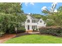 Beautiful two-story house with manicured front yard, blooming bushes, and mature trees in a desirable neighborhood at 725 Littleleaf Ct, Holly Springs, NC 27540