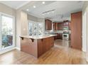 Kitchen island features granite countertops and beautiful wood floors; a chef's dream! at 725 Littleleaf Ct, Holly Springs, NC 27540