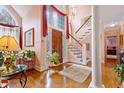 Grand foyer with a staircase, chandelier, arched window, and hardwood floors offering a bright and inviting entrance at 725 Thompson Rd, Garner, NC 27529