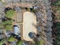Aerial view of horse arena with adjacent buildings and lush surrounding trees at 8809 Farrington Mill Rd, Chapel Hill, NC 27517