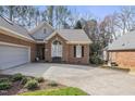 Brick house with an attached garage and well-manicured front yard at 933 Tanworth Dr, Raleigh, NC 27615