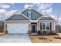 Well-maintained single-Gathering home with a two-car garage, tidy landscaping, and a patriotic touch with an American flag at 10 Parker Pond Ct, Durham, NC 27703