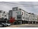 A modern townhome features a gray and white exterior with large windows and a small red maple tree at 1007 Hundley Pl, Durham, NC 27701