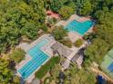 Aerial view of the community pool featuring multiple swimming areas, lounge chairs and mature trees at 101 Rustic Wood Ln, Cary, NC 27518