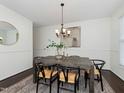 Elegant dining room features a wooden table, six chairs, chandelier, and stylish decor at 104 Deep Gap Run, Cary, NC 27519