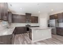 Modern kitchen features granite countertops, stainless steel appliances, and an island at 1077 Kafka Dr, Fuquay Varina, NC 27526
