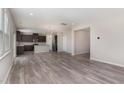 Open concept living space with hardwood floors connecting the kitchen and living room at 1077 Kafka Dr, Fuquay Varina, NC 27526
