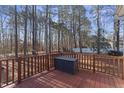 A wooden deck is surrounded by a wooded area that gives shade in the summer at 111 Legacy Ln, Durham, NC 27713