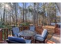 Wooden deck with outdoor seating area and peaceful, wooded surroundings at 111 Legacy Ln, Durham, NC 27713