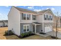 Side angle of a charming gray two-story home with a two-car garage at 1122 Briar Rose Ln, Durham, NC 27704