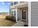 A close up of the front door to a charming gray two-story home at 1122 Briar Rose Ln, Durham, NC 27704