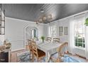 Formal dining room with a striking dark ceiling, hardwood floors, and ample natural light at 12516 Shallowford Dr, Raleigh, NC 27614