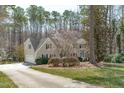 Exterior of home with attached garage, lush landscaping, and blooming trees at 12516 Shallowford Dr, Raleigh, NC 27614