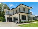 Striking contemporary home showcasing a two-car garage, sleek lines, and meticulous landscaping at 132 Edward Booth Ln, Durham, NC 27713