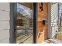 Modern covered entrance featuring wood accents, sleek lighting, and stylish mailbox, showcasing the home's architectural details at 1407 Carroll St, Durham, NC 27707
