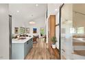 Open-concept design seamlessly connecting the spacious kitchen with the inviting living area flooded with natural light at 1407 Carroll St, Durham, NC 27707