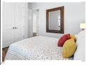 Comfortable bed with decorative pillows and hardwood floors, enhancing the bedroom's warmth and inviting ambiance at 153 Abercorn Cir, Chapel Hill, NC 27516