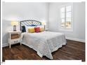 Cozy bedroom with hardwood floors, a comfortable bed, and a bright window, creating a serene and restful atmosphere at 153 Abercorn Cir, Chapel Hill, NC 27516