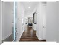 Inviting hallway with hardwood floors leads to a bright and airy living space, enhancing the home's modern feel at 153 Abercorn Cir, Chapel Hill, NC 27516
