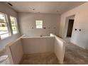 Unfinished kitchen features an island, sheetrocked walls, and a window for natural lighting at 20 Trescott St, Smithfield, NC 27577