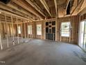Open living space featuring wood frame construction, with natural light from windows and door to the outdoors at 20 Trescott St, Smithfield, NC 27577