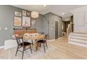 Contemporary dining room featuring modern decor, wood floors, and a stairway leading to the second floor at 2001 Regal Dr # 89, Durham, NC 27703