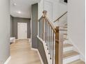 Inviting home entryway features wood floors and staircase with a custom railing leading upstairs at 2001 Regal Dr # 89, Durham, NC 27703